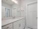 Bright bathroom features a vanity with white cabinets and a large mirror at 3007 Buffett Ln, Monroe, NC 28110