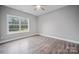 Well-lit bedroom featuring gray walls, wood-look floors, and a window at 3007 Buffett Ln, Monroe, NC 28110