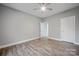 Spacious bedroom with gray walls, wood-look floors, and a ceiling fan at 3007 Buffett Ln, Monroe, NC 28110