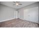 Spacious bedroom with gray walls, wood-look floors, and double doors at 3007 Buffett Ln, Monroe, NC 28110