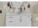 Elegant bathroom vanity with white cabinets and marble countertop at 6920 Stillmeadow Dr, Charlotte, NC 28277