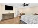 Spacious bedroom with wood floors, king bed, and ceiling fan at 6920 Stillmeadow Dr, Charlotte, NC 28277