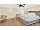 Bright bedroom with king-size bed, hardwood floors, and ceiling fan at 6920 Stillmeadow Dr, Charlotte, NC 28277
