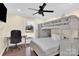 Bedroom with a built-in bunk bed, desk, and wood floors at 6920 Stillmeadow Dr, Charlotte, NC 28277