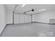 Attached garage with epoxy coated flooring at 6920 Stillmeadow Dr, Charlotte, NC 28277