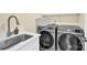 Laundry room with modern Samsung washer and dryer at 6920 Stillmeadow Dr, Charlotte, NC 28277
