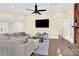 Bright living room with hardwood floors and a large TV at 6920 Stillmeadow Dr, Charlotte, NC 28277