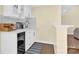 Small wet bar with beverage fridge and quartz countertop at 6920 Stillmeadow Dr, Charlotte, NC 28277