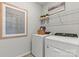 Convenient laundry room with washer, dryer, and shelving at 7112 Brookview Ln, Sherrills Ford, NC 28673