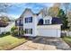 Two-story house with white siding, a white garage door, and landscaping at 7317 Frances Irene Dr, Charlotte, NC 28215