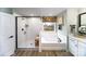 Bathroom with soaking tub, walk-in shower, and double vanity at 8024 Plymouth Dr, Sherrills Ford, NC 28673