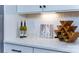 Stylish kitchen detail showing hexagon tile backsplash, wine rack, and quartz countertops at 8024 Plymouth Dr, Sherrills Ford, NC 28673