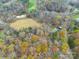 Aerial view of house and surrounding property with autumn foliage at 143 Ponokah Ln, Statesville, NC 28677