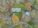 Bird's-eye view of a house, detached barn, and surrounding trees at 143 Ponokah Ln, Statesville, NC 28677
