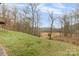 Serene backyard with expansive grassy area and wooded backdrop at 143 Ponokah Ln, Statesville, NC 28677