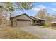 House exterior with attached garage and spacious driveway at 143 Ponokah Ln, Statesville, NC 28677