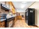 Kitchen features dark wood cabinets, granite countertops, and black appliances at 143 Ponokah Ln, Statesville, NC 28677