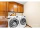Laundry room with washer, dryer, and upper cabinets at 143 Ponokah Ln, Statesville, NC 28677