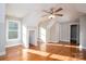 Dormer bedroom with hardwood floors, multiple windows, and a ceiling fan at 314 Henry Chapel Rd, Belmont, NC 28012