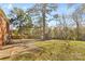 Spacious backyard with large grassy area, mature trees, and patio at 1532 Starbrook Dr, Charlotte, NC 28210