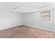Finished basement bedroom with carpet, neutral walls and window with blinds at 1532 Starbrook Dr, Charlotte, NC 28210