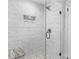 Basement shower with marble tile and built-in seat at 1532 Starbrook Dr, Charlotte, NC 28210