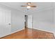 Hardwood floor bedroom with ceiling fan and double door closet at 1532 Starbrook Dr, Charlotte, NC 28210