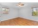 Well-lit bedroom with hardwood floors and ceiling fan at 1532 Starbrook Dr, Charlotte, NC 28210