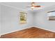 Hardwood floor bedroom with two windows and a ceiling fan at 1532 Starbrook Dr, Charlotte, NC 28210