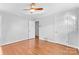 Hardwood floor bedroom with ceiling fan and double door closet at 1532 Starbrook Dr, Charlotte, NC 28210