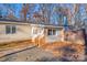 Tan colored single wide mobile home with brick steps and wood fence at 465 Lakedale Dr, Clover, SC 29710