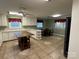 Kitchen with island, white cabinets, and tiled floors at 6650 Sherrills Ford Rd, Salisbury, NC 28147