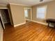 Well-lit bedroom with hardwood floors and mirrored closet at 6650 Sherrills Ford Rd, Salisbury, NC 28147