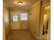 Inviting entryway with tile flooring, stained glass window, and coat hooks at 6650 Sherrills Ford Rd, Salisbury, NC 28147