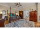 Main bedroom with hardwood floors, a large window and ceiling fan at 9929 Devonshire Dr, Huntersville, NC 28078