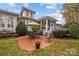 Stone patio with seating area and umbrella at 9929 Devonshire Dr, Huntersville, NC 28078