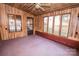 Sunroom with wood paneling, carpet and lots of windows at 1032 Old Charlotte Rd, Concord, NC 28027