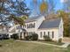 Two-story house with beige siding, dark shutters, and a two-car garage at 12202 Shiro Ct, Huntersville, NC 28078