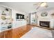 Living room featuring built-in shelving, fireplace, and hardwood floors at 12202 Shiro Ct, Huntersville, NC 28078