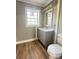 Simple bathroom with gray vanity and wood-look flooring at 133 Elmwood Rd, Statesville, NC 28625