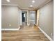 Light-filled hallway with wood-look floors and access to multiple rooms at 133 Elmwood Rd, Statesville, NC 28625