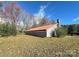 Gray stone building with red metal roof and partial view of yard at 133 Elmwood Rd, Statesville, NC 28625