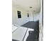Screened porch with gray flooring and access to the home's entrance at 133 Elmwood Rd, Statesville, NC 28625