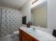 Bathroom with white vanity, shower, and patterned curtain at 1335 Huckleberry Dr, Lincolnton, NC 28092