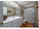 Bathroom with white vanity, shower, and floral curtain at 1335 Huckleberry Dr, Lincolnton, NC 28092
