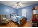 Bedroom with floral bedding, armchair, and hardwood floors at 1335 Huckleberry Dr, Lincolnton, NC 28092
