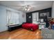 Bedroom with hardwood floors, large windows, and a red bedspread at 1335 Huckleberry Dr, Lincolnton, NC 28092