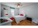 Bedroom with white bedding, red accents, and hardwood floors at 1335 Huckleberry Dr, Lincolnton, NC 28092