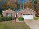 Brick ranch house with attached garage and landscaped yard at 1335 Huckleberry Dr, Lincolnton, NC 28092