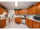Kitchen boasts ample wood cabinets, stainless steel appliances, and tile floors at 1335 Huckleberry Dr, Lincolnton, NC 28092